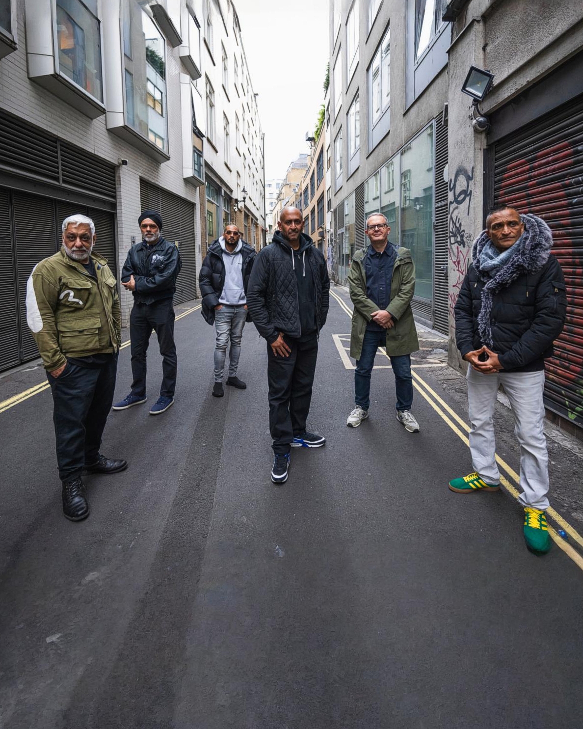 A group of men standing in the street
