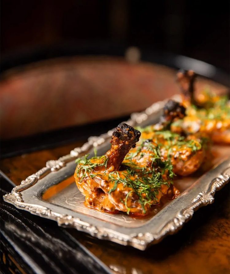 Cooked chicken chops on a silver platter